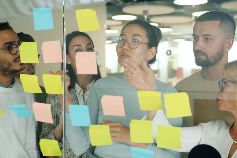 Diverse team collaborating with sticky notes during a planning session
